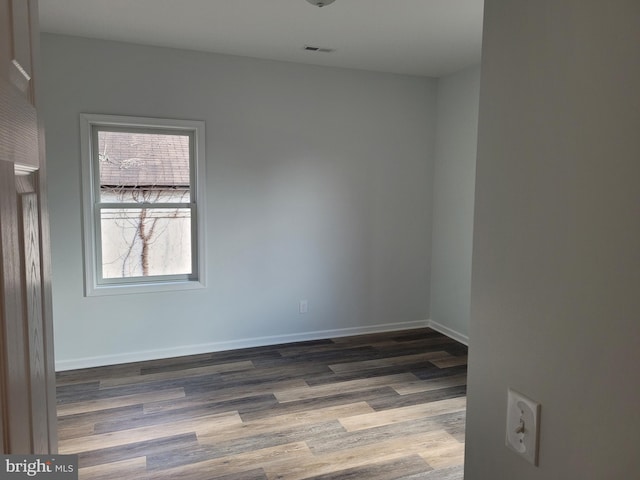 unfurnished room featuring hardwood / wood-style flooring