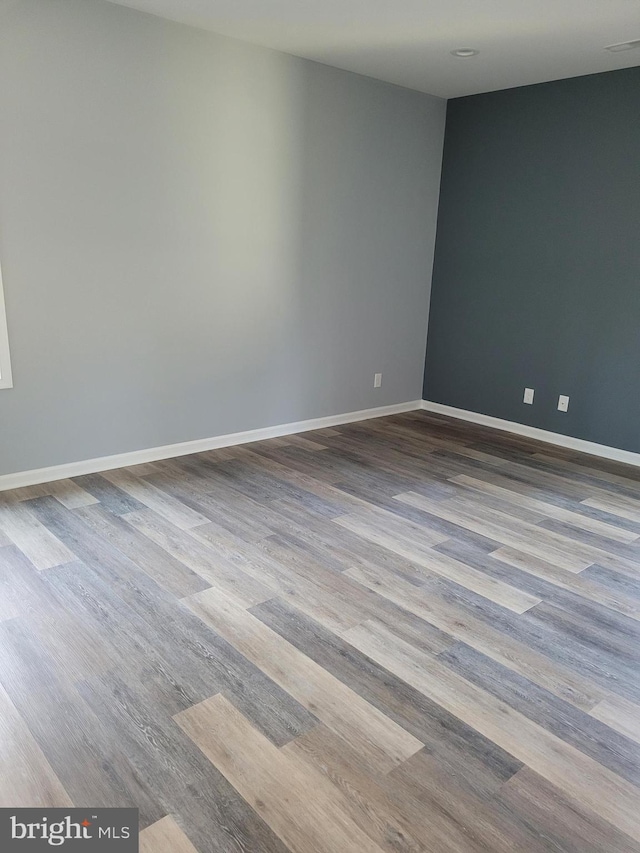 unfurnished room with hardwood / wood-style flooring