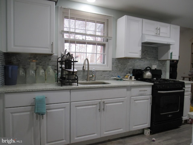 kitchen with backsplash, sink, white cabinetry, gas stove, and wood-type flooring