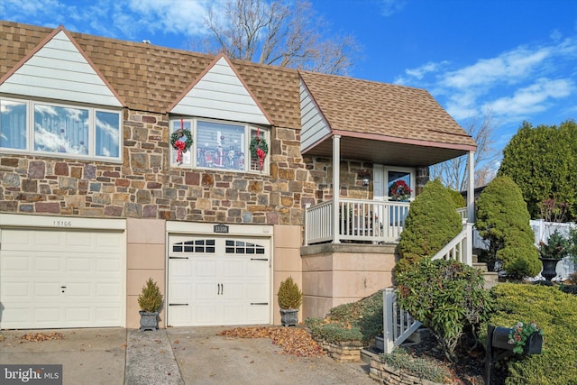 view of front of property featuring a balcony and a garage