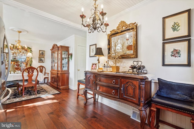 living area featuring hardwood / wood-style floors, a notable chandelier, and ornamental molding