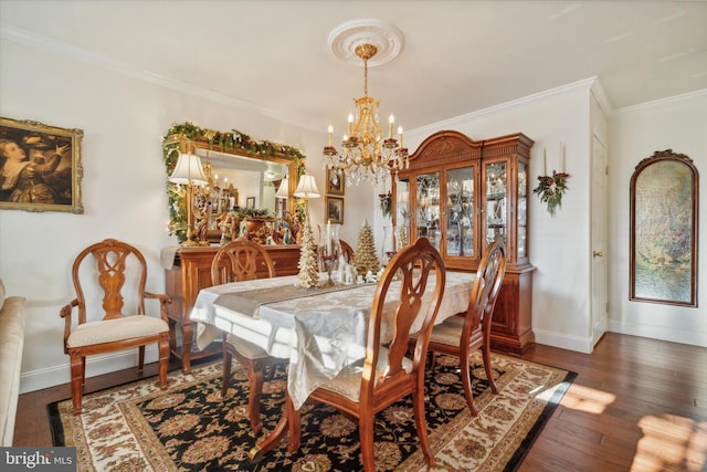 dining room with dark hardwood / wood-style flooring, an inviting chandelier, and crown molding