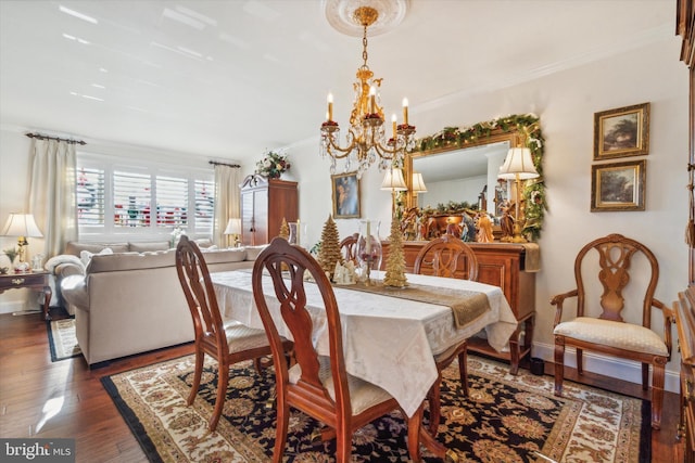 dining area with crown molding, dark hardwood / wood-style flooring, and an inviting chandelier