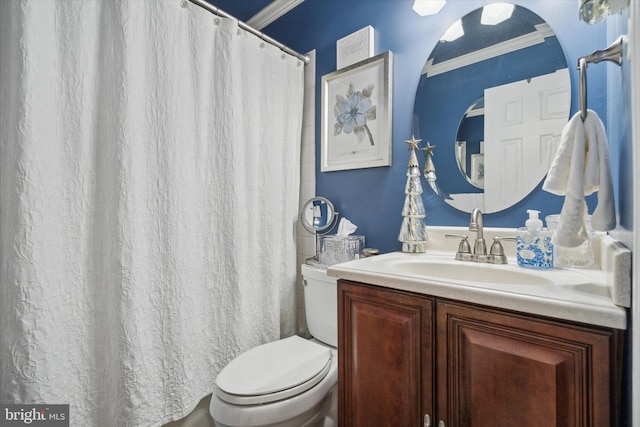 bathroom with vanity, toilet, and ornamental molding