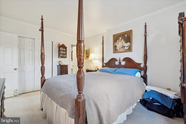 carpeted bedroom with a closet and ornamental molding