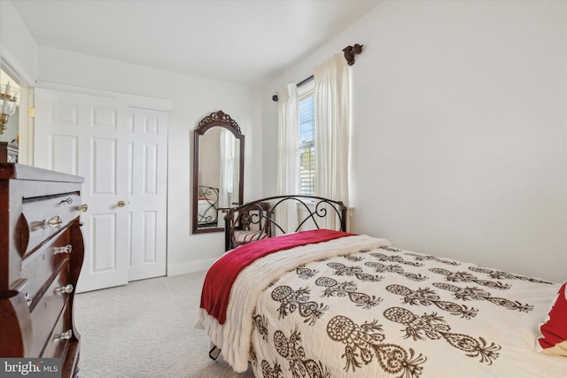 carpeted bedroom with a closet