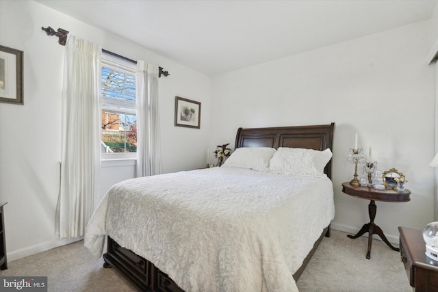 bedroom featuring light carpet