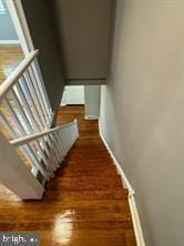 stairs featuring hardwood / wood-style flooring