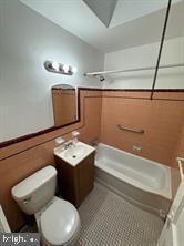 full bathroom featuring shower / bathing tub combination, tile patterned floors, vanity, and toilet