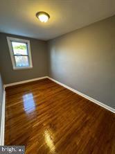 spare room with dark hardwood / wood-style floors