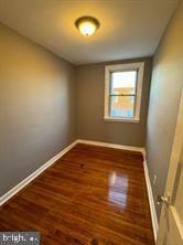 unfurnished room with dark hardwood / wood-style floors