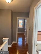 hall with dark hardwood / wood-style flooring