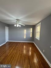 empty room with dark hardwood / wood-style flooring