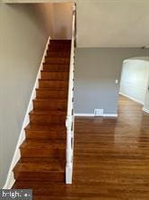 stairway with hardwood / wood-style flooring