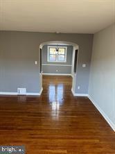 spare room featuring dark wood-type flooring