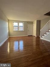 unfurnished living room featuring dark wood-type flooring