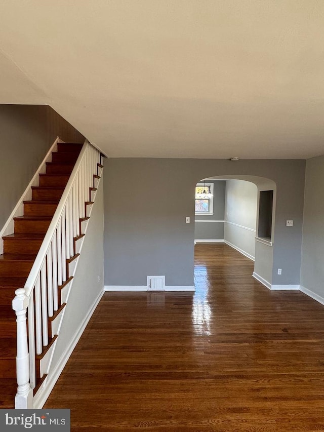 unfurnished living room with dark hardwood / wood-style flooring