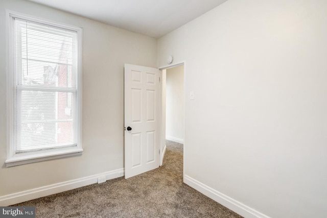 unfurnished room featuring light carpet and a healthy amount of sunlight