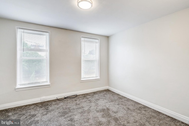 empty room with a healthy amount of sunlight and light colored carpet