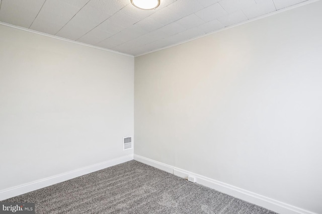 carpeted empty room featuring ornamental molding