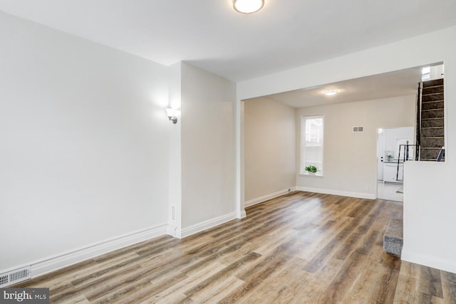 spare room with wood-type flooring