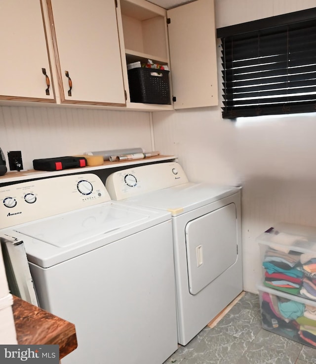 laundry area with cabinets and washer and clothes dryer