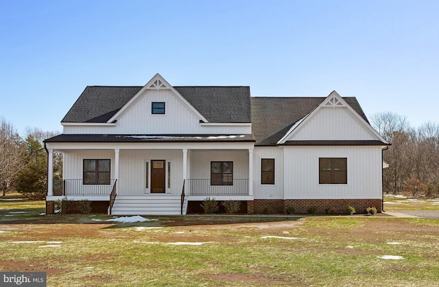 modern inspired farmhouse featuring a front yard and a porch