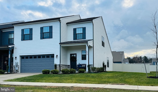 view of front of property featuring a garage and a front lawn