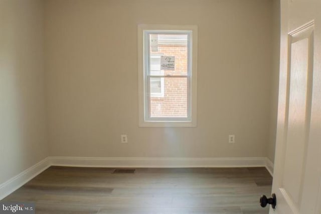 unfurnished room featuring wood-type flooring