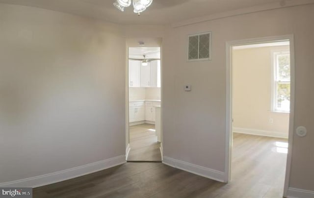 corridor with hardwood / wood-style floors