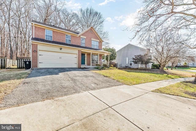 front facade with a porch, a garage, and a front yard