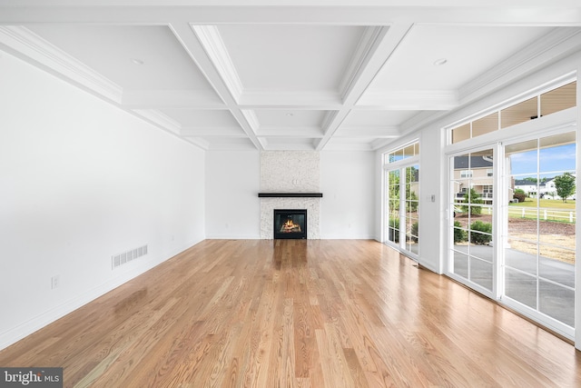 unfurnished living room featuring coffered ceiling, light hardwood / wood-style flooring, beamed ceiling, crown molding, and a fireplace