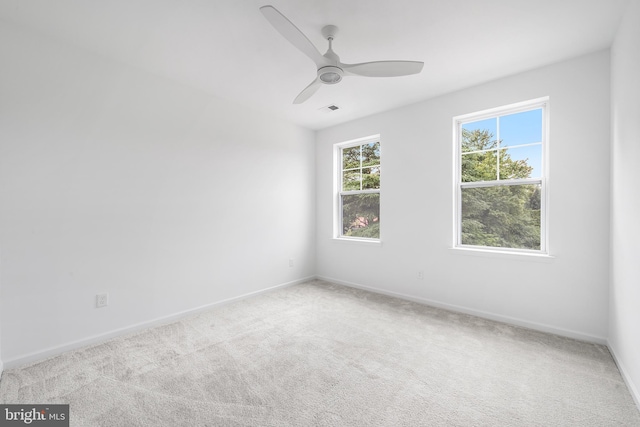 empty room with light colored carpet and ceiling fan