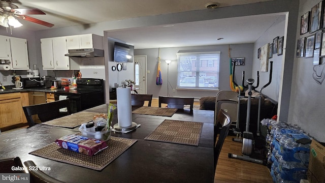 dining area featuring ceiling fan and dark hardwood / wood-style floors