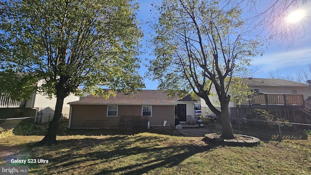 rear view of property with a yard