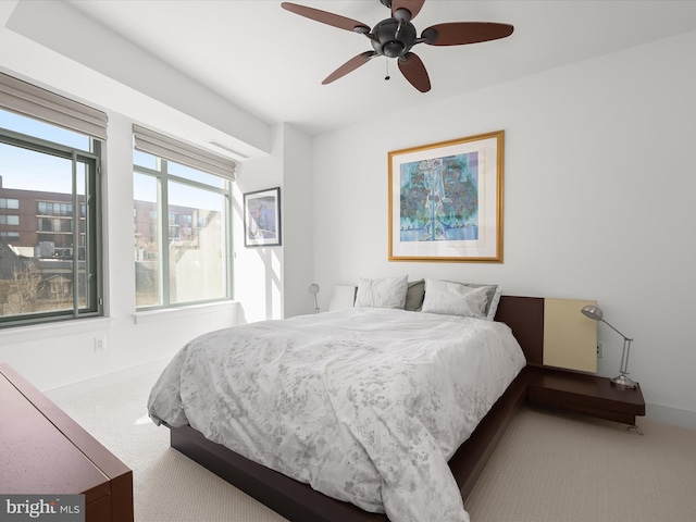 bedroom with carpet flooring, a ceiling fan, and baseboards