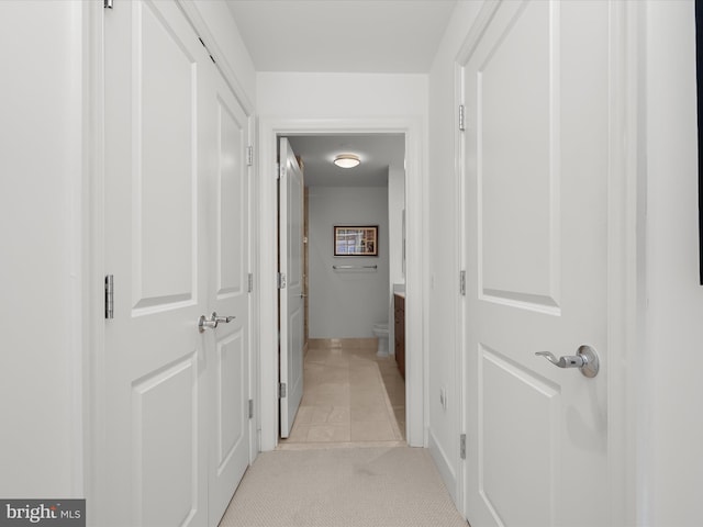 hallway featuring light carpet