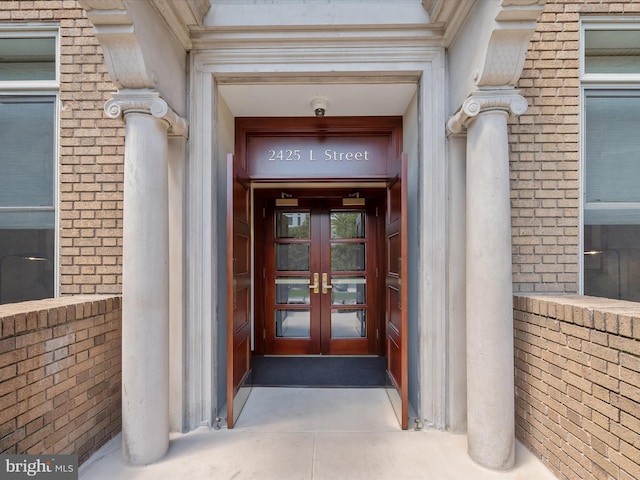 doorway to property with french doors and brick siding