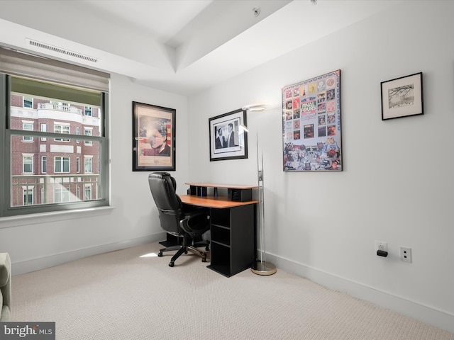 office featuring baseboards, visible vents, a raised ceiling, and carpet flooring