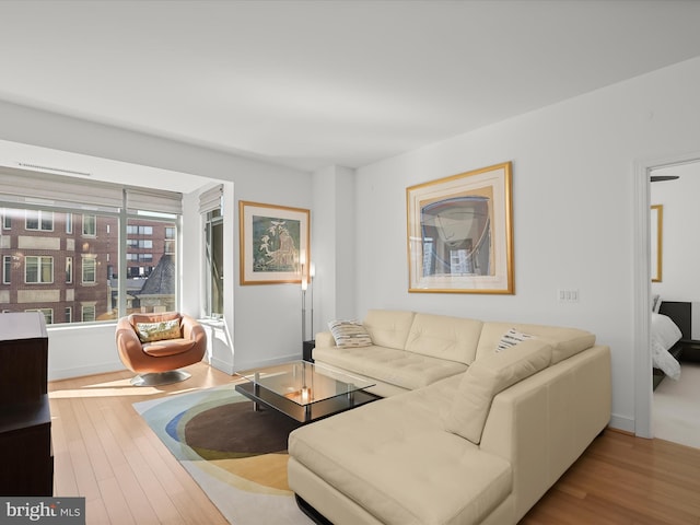 living room featuring wood finished floors and baseboards