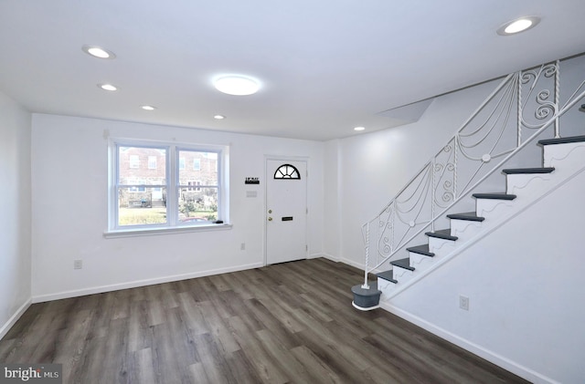 entryway with dark hardwood / wood-style flooring