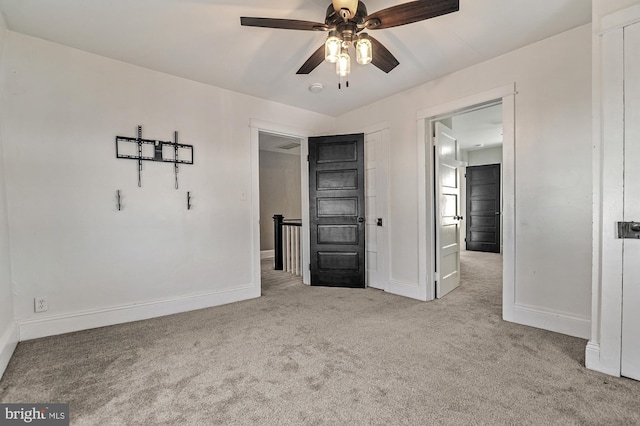 unfurnished bedroom with ceiling fan and light carpet