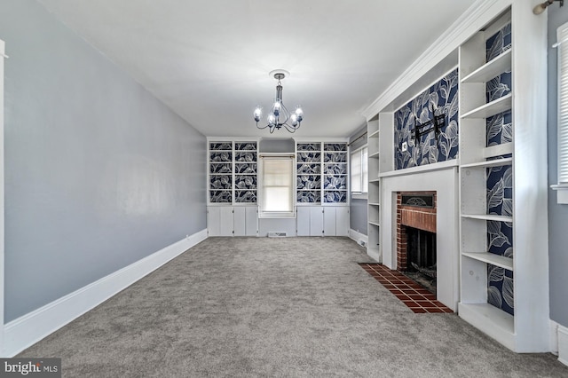 unfurnished living room with a fireplace, carpet floors, an inviting chandelier, and crown molding