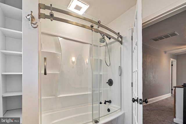 bathroom featuring shower / bath combination with glass door