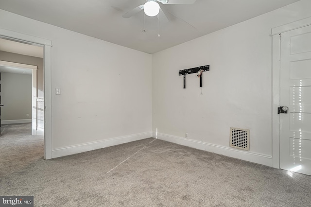 unfurnished room with light colored carpet and ceiling fan