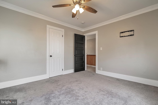 unfurnished room with carpet floors, ceiling fan, and crown molding