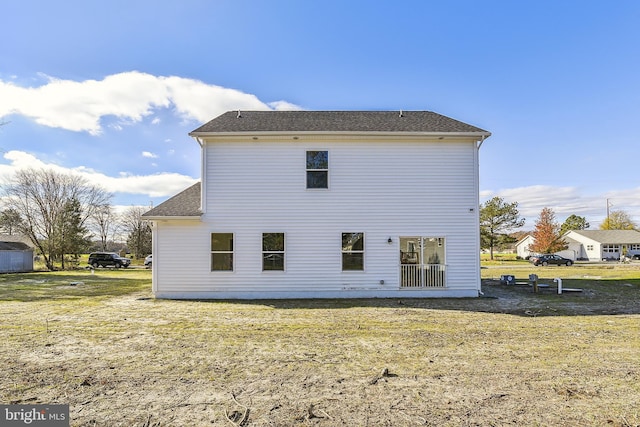 back of property with a lawn