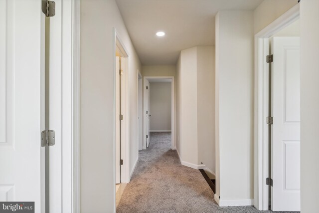 hallway featuring light carpet