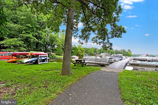 view of yard featuring a boat dock and a water view