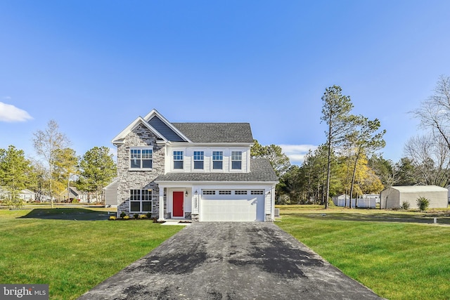 view of front of property with a garage and a front yard